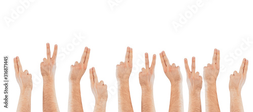 Fingers raised up on a light background. The concept of applying, willingness to ask questions. Hands raised up.