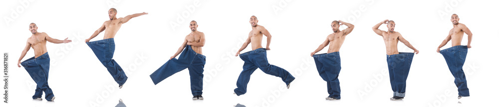 Man in dieting concept with oversized jeans Man in dieting concept with oversized jeans