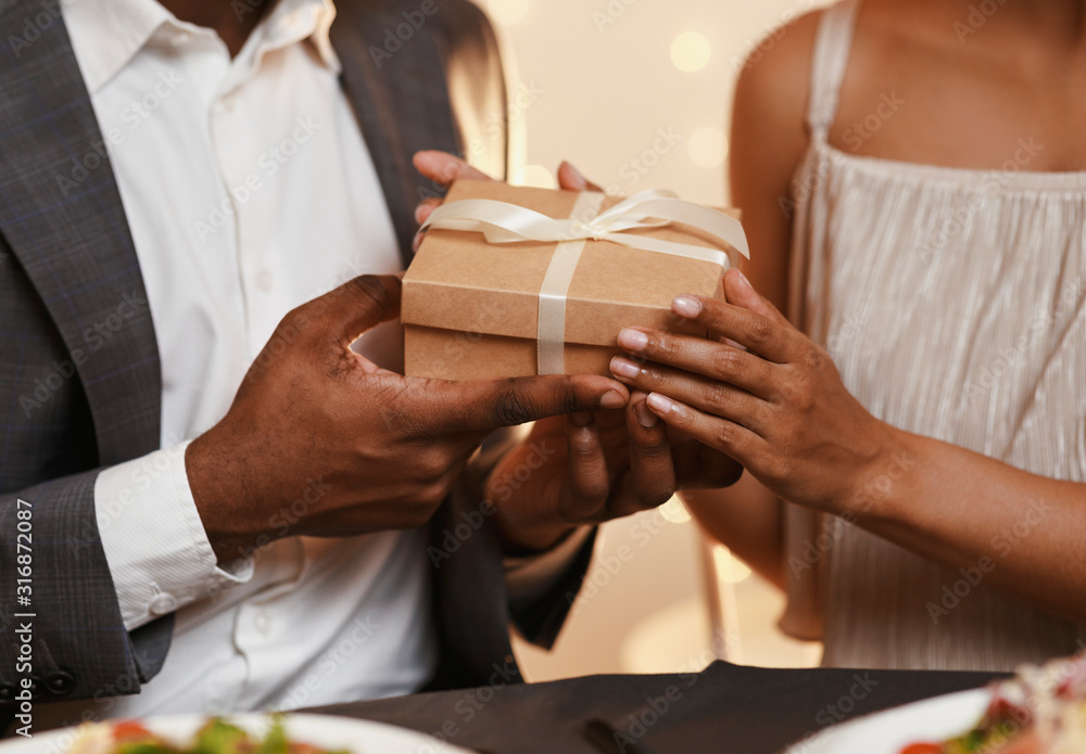 Cropped of man and woman holding gift box