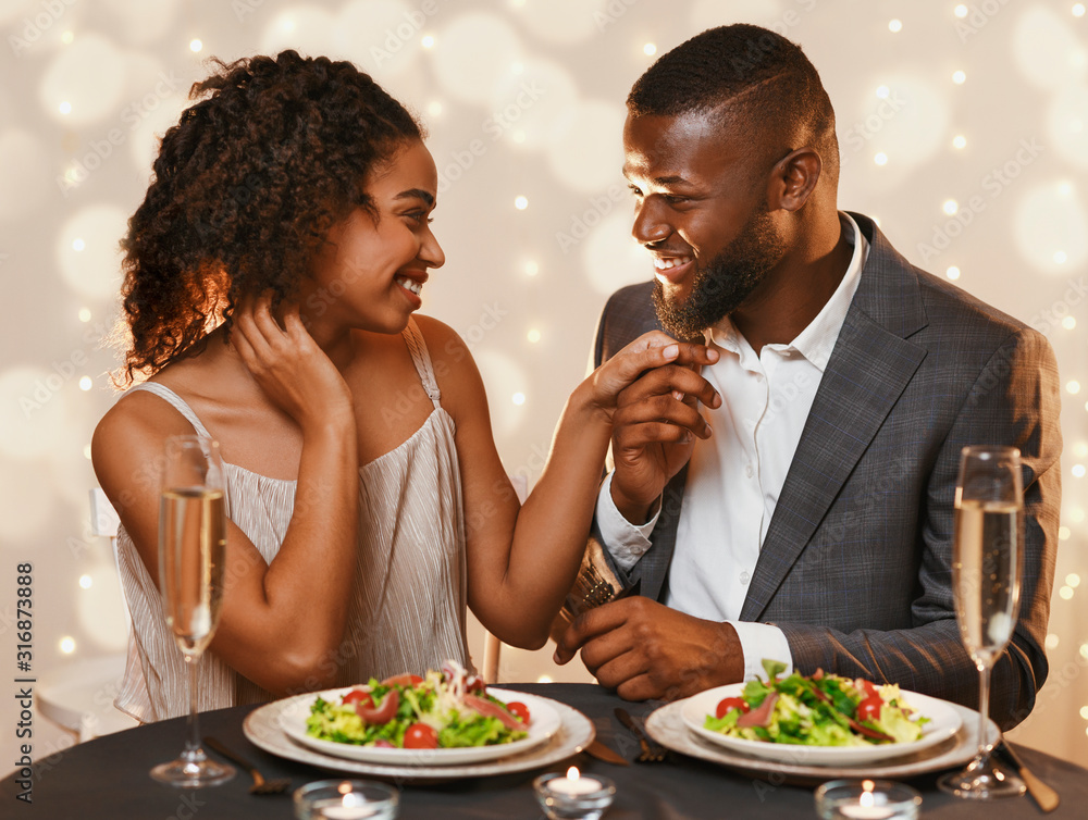 Fancy black couple having festive dinner at restaurant Fancy black couple having festive dinner at restaurant