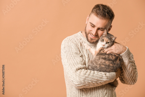 Man with cute cat on color ...