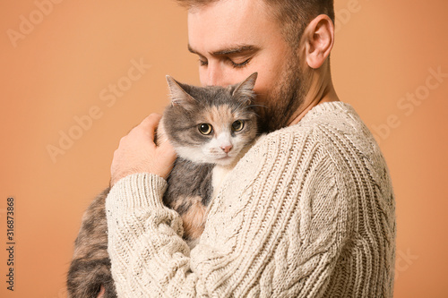 Man with cute cat on color ...