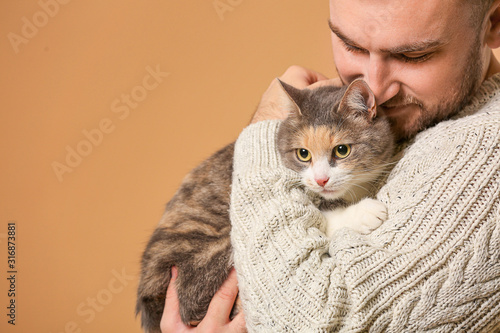 Man with cute cat on color ...