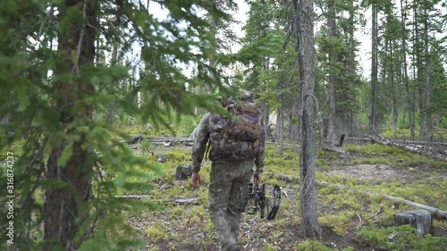 Hunter with Bow Leaves Camp Camo Colorado