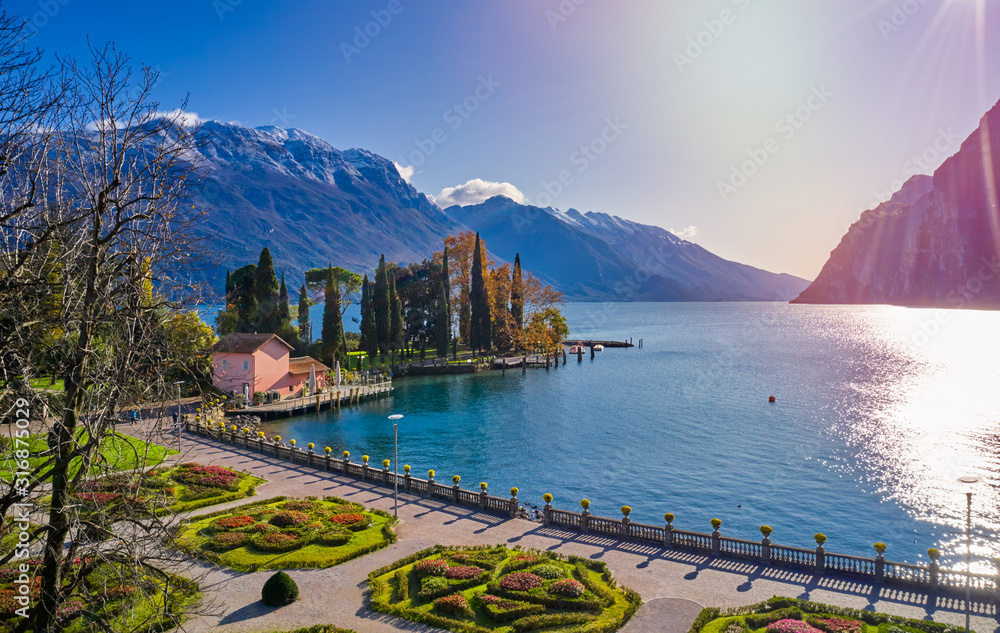 Beautiful and colorful autumn in Riva del Garda,Panorama of the gorgeous Garda lake surrounded by mountains in the autumn time