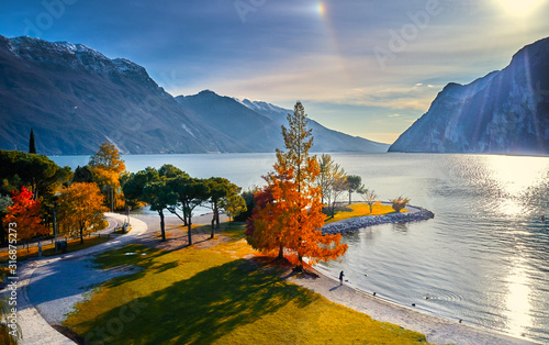 Fototapeta Naklejka Na Ścianę i Meble -  Beautiful and colorful autumn in Riva del Garda, Garda lake surrounded by mountains, Trentino Alto Adige region, Lago di garda, italy
