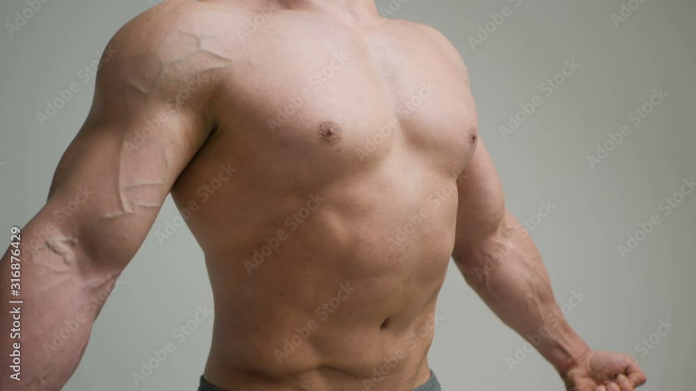 Muscular bodybuilder guy doing exercises with dumbbells isolated on white background Muscular bodybuilder guy doing exercises with dumbbells isolated on white background