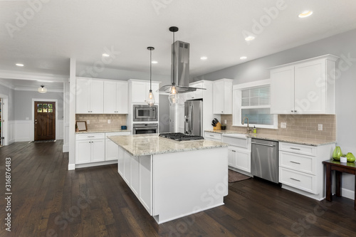 Beautiful kitchen in new home, with stainless steel appliances