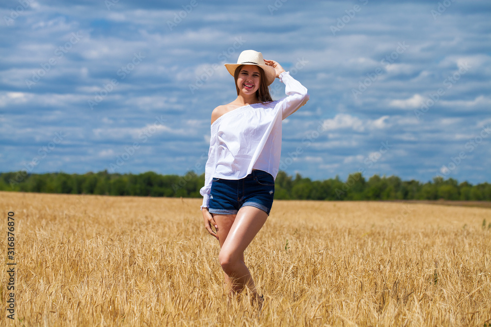 Young brunette woman in white shirt and blue jeans shorts Young brunette woman in white shirt and blue jeans shorts