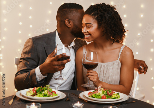 Romantic black couple having dinner at restaurant