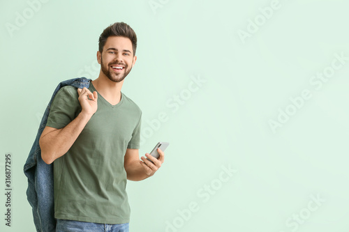 Happy young man with mobile...