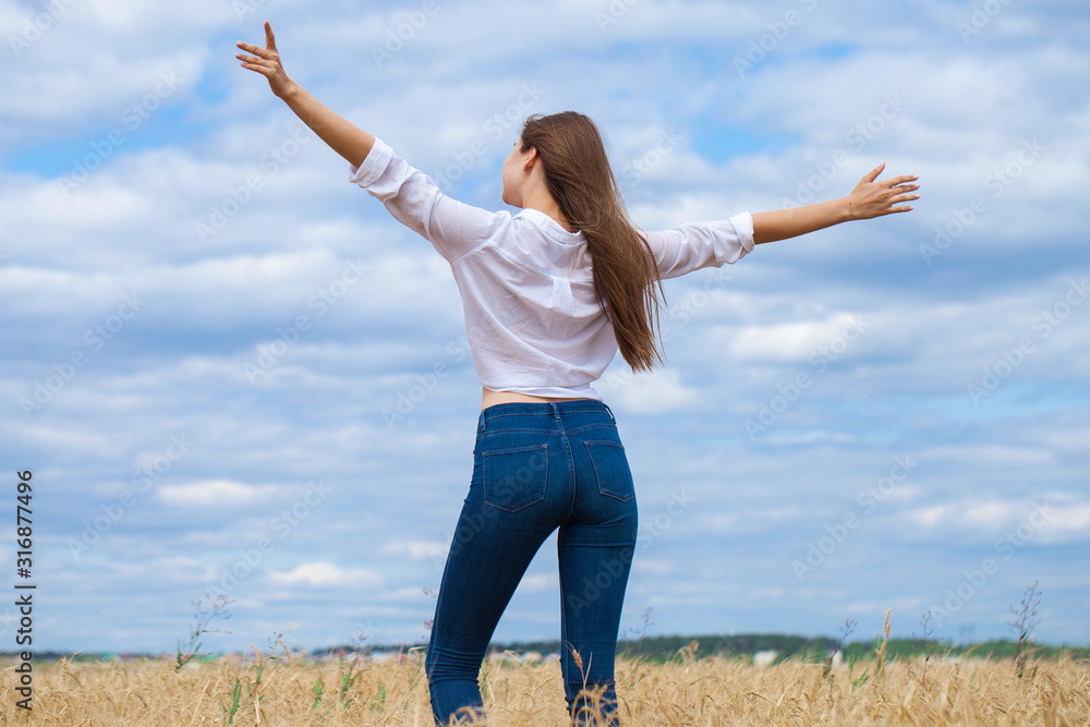 Young brunette woman in white shirt and blue jeans Young brunette woman in white shirt and blue jeans