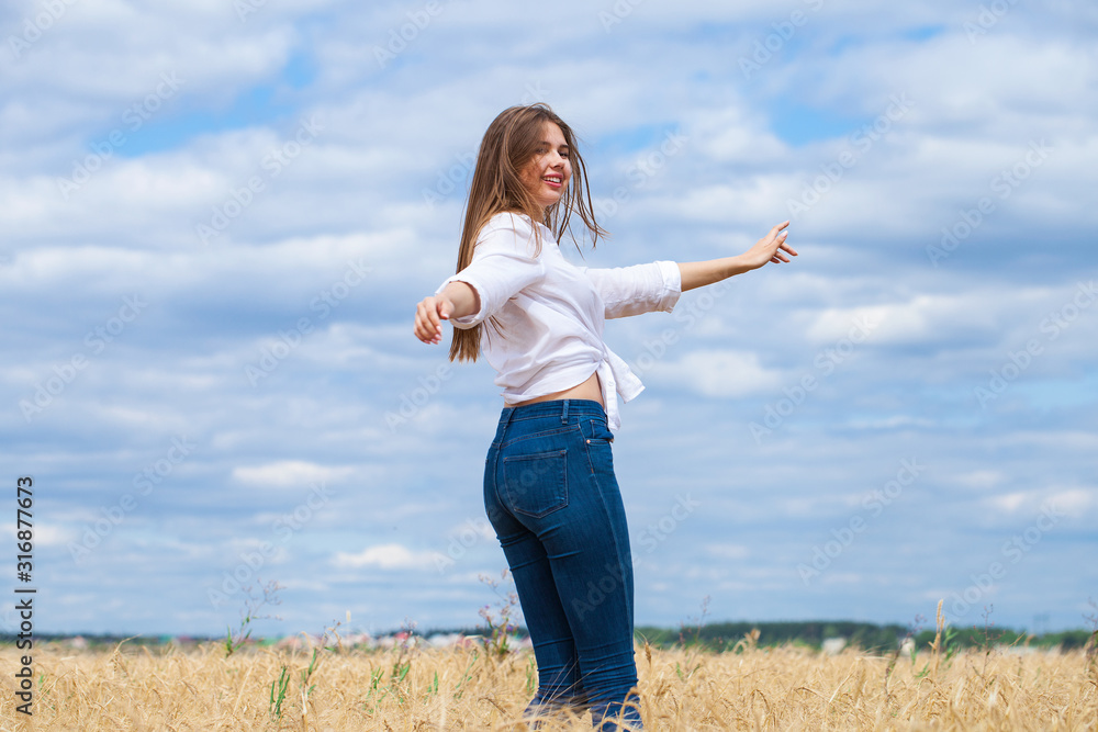 Young brunette woman in white shirt and blue jeans Young brunette woman in white shirt and blue jeans