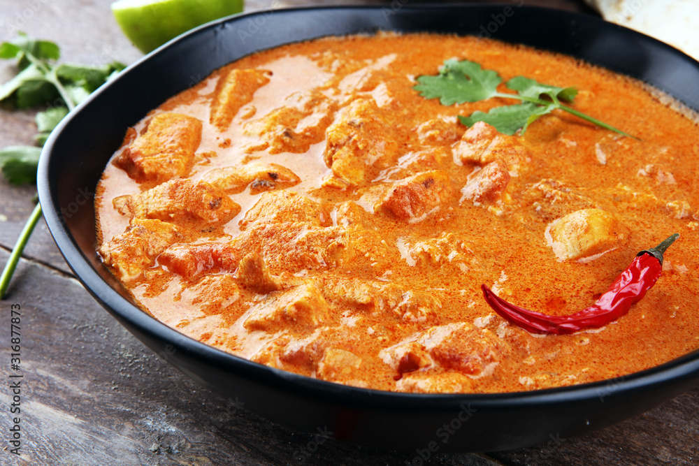 Chicken tikka masala spicy curry meat food in pot with rice and naan bread. indian food Chicken tikka masala spicy curry meat food in pot with rice and naan bread. indian food