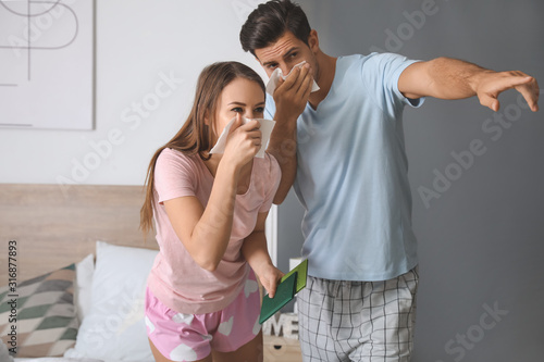 Young couple gasping at hom...