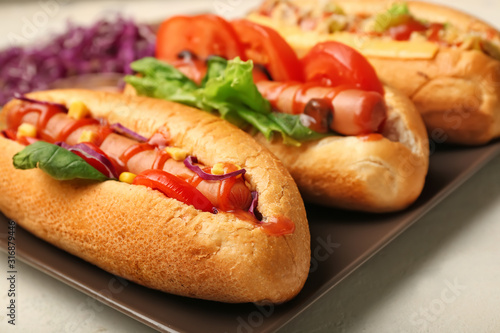 Tasty hot dogs on light background, closeup