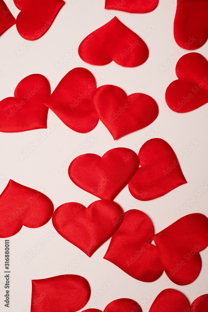 Valentine's Day. Many red hearts on a white background. Texture.