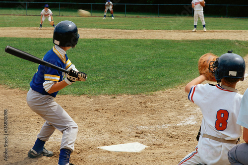 Fotografie Young batter preparing to hit baseball