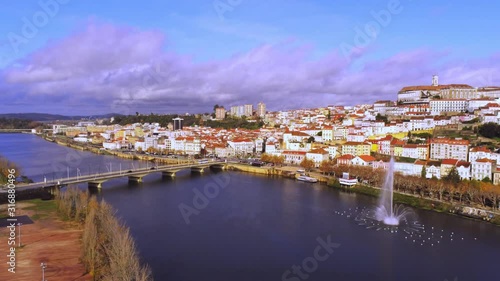 Santa Clara Bridge On Mondego River with a fountain, Coimbra Cityscape . Aerial panorama zoom in
