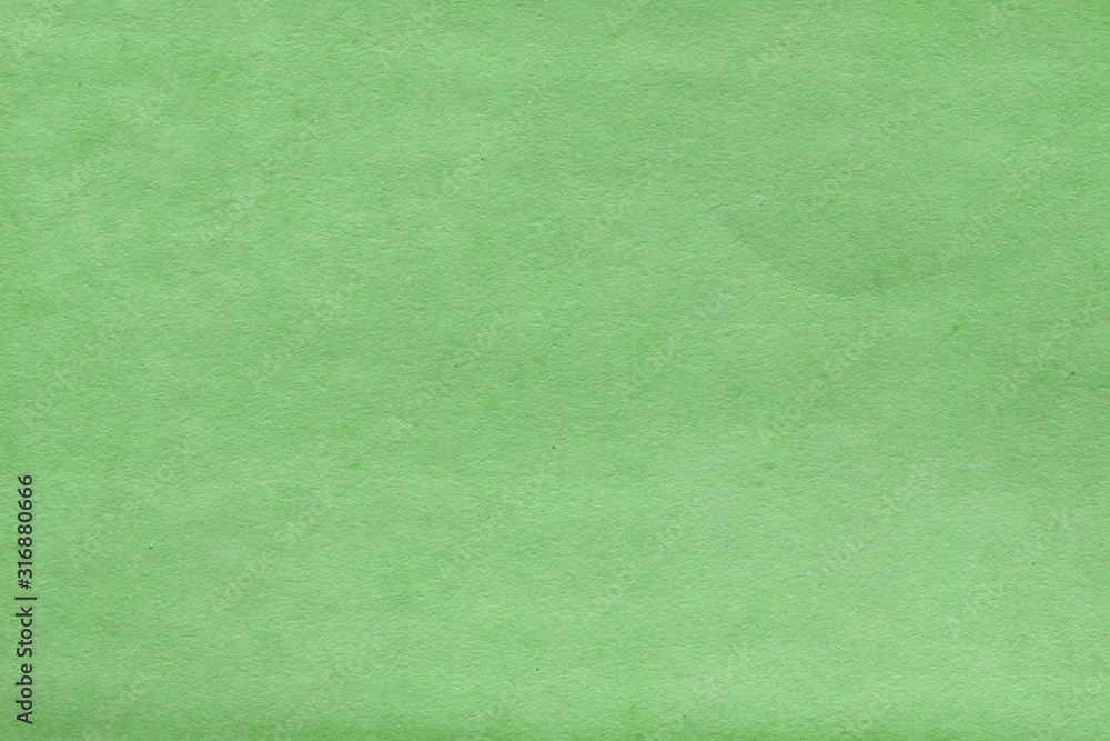 Fototapeta premium Cardboard green abstract pattern texture close-up. Retro old paper background. Grunge concrete wall. Vintage blank wallpaper.
