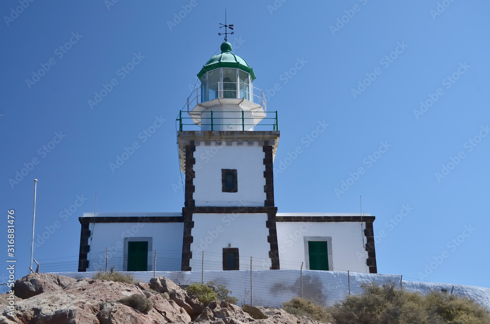 Akrotiri Lighthouse on Santorini Greece, sunny day, blue sky