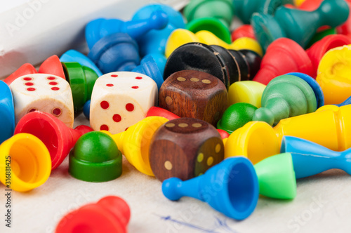 Colorful figures and dices of ludo family board game.