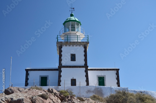 Akrotiri Lighthouse on Santorini Greece, sunny day, blue sky