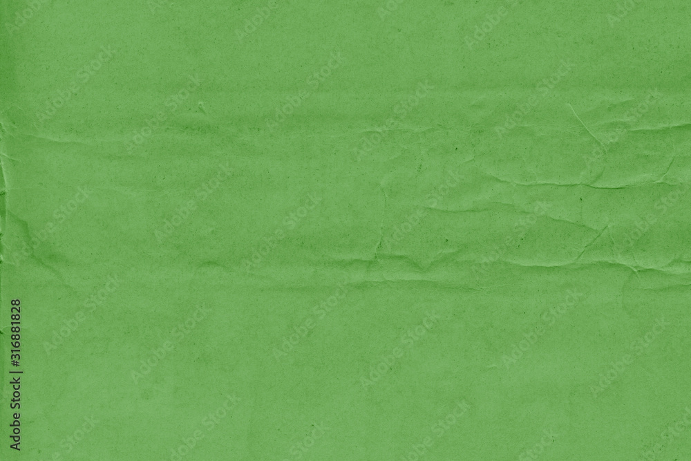 Fototapeta premium Cardboard green abstract pattern texture close-up. Retro old paper background. Grunge concrete wall. Vintage blank wallpaper.