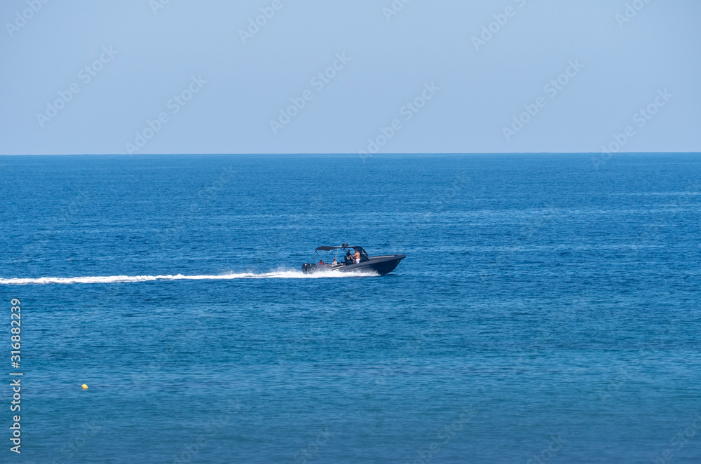 speedboat in blue sea horizon