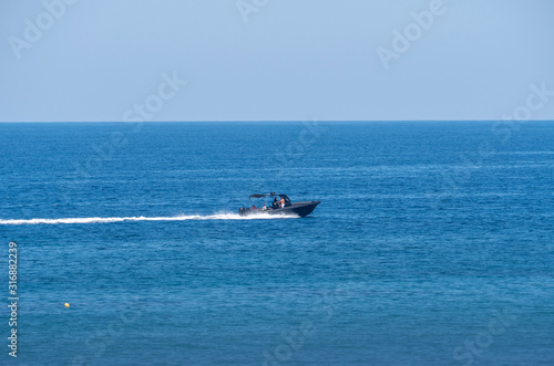 speedboat in blue sea horizon