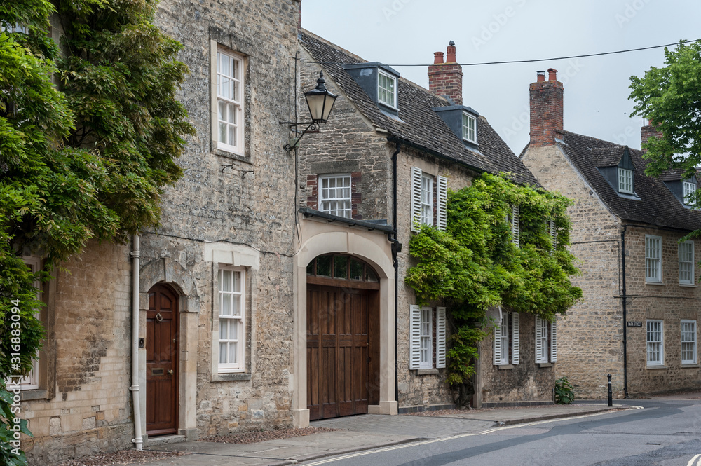 WOODSTOCK, UK - MAY 28, 2018:  Wisteria on Thomas Chaucer's House & servants' Cottage in the small town of Woodstock, Park Street - Oxfordshire, England - UK