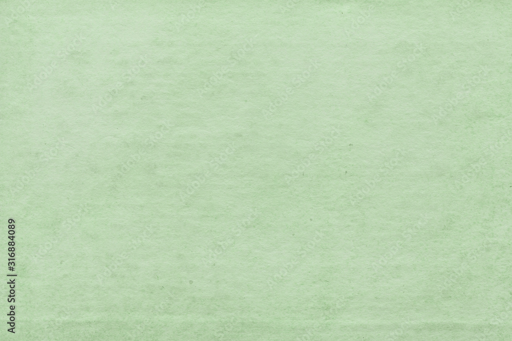 Fototapeta premium Cardboard green abstract pattern texture close-up. Retro old paper background. Grunge concrete wall. Vintage blank wallpaper.