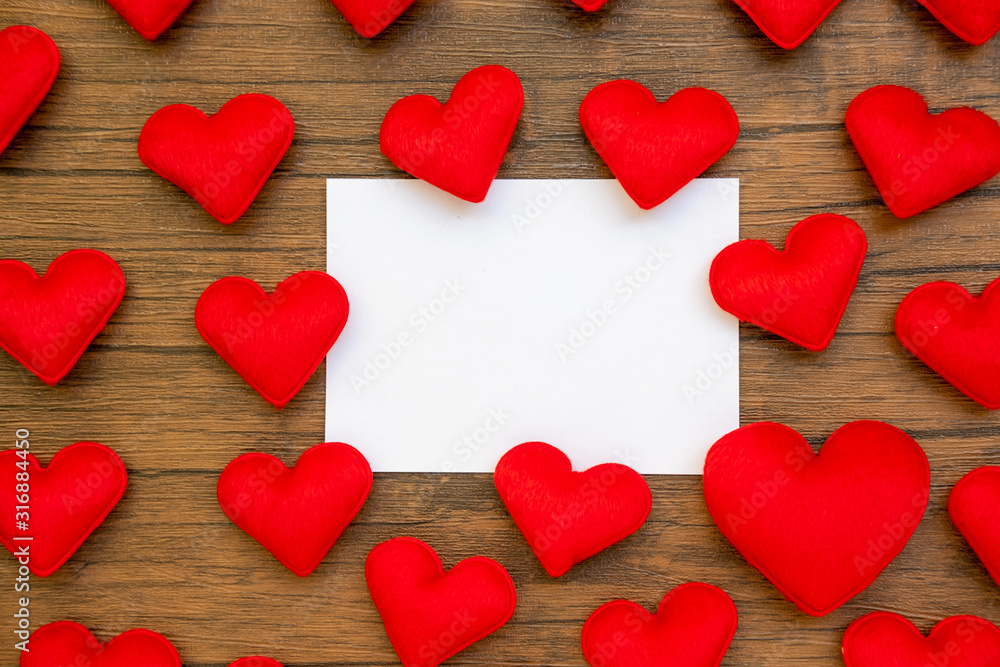 Obraz premium hearts composition. Frame made of red hearts, on wood background. Valentines day background. Flat lay, top view, copy space.