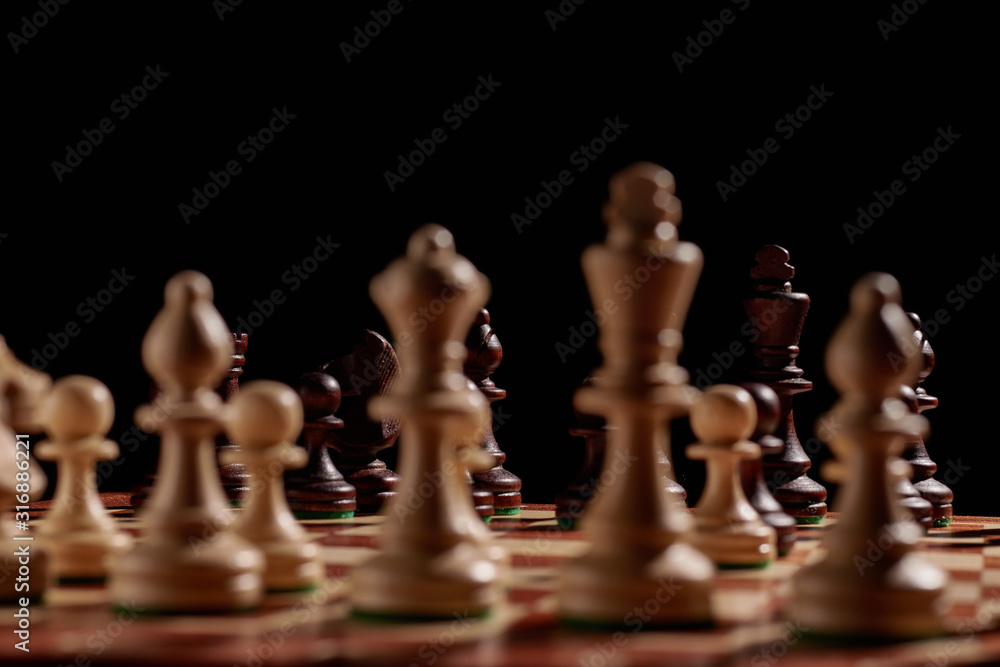 Chess black and white pieces on a game board Chess black and white pieces on a game board