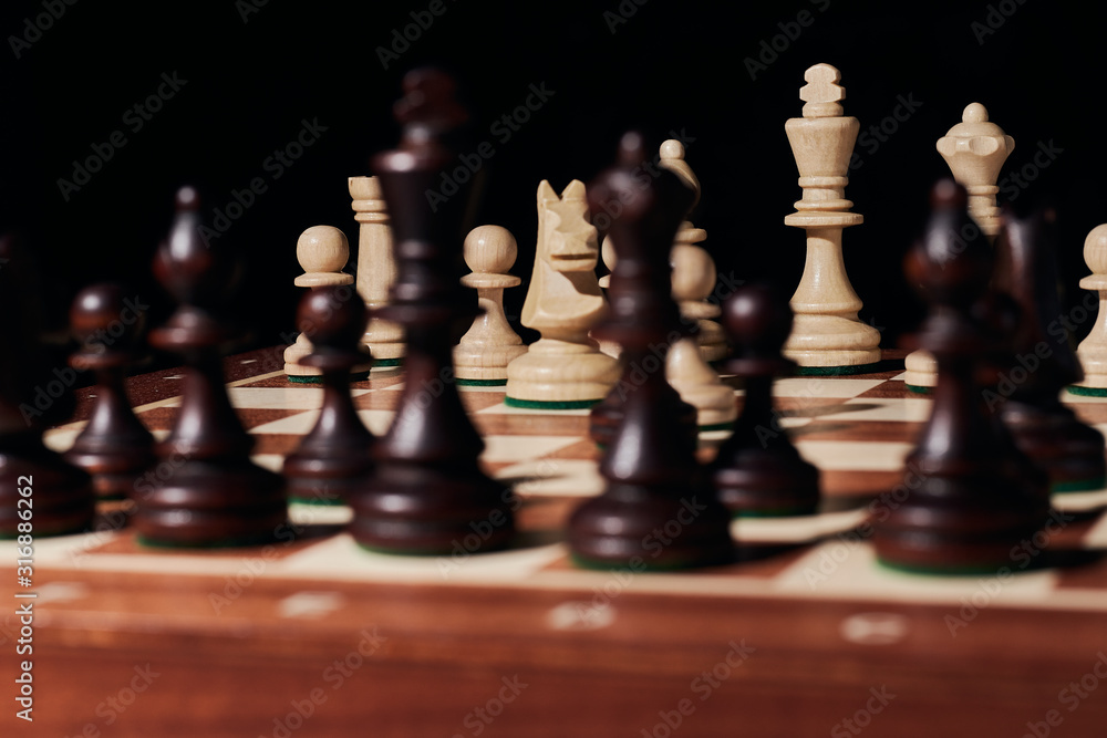 Chess black and white pieces on a game board Chess black and white pieces on a game board