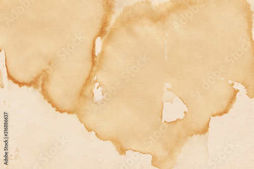 Vintage and old looking coffee cup stain background. Painted with a tea retro texture. Grunge paper for drawing. Ancient book page.