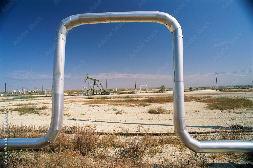 Piping with pump jack in background Piping with pump jack in background