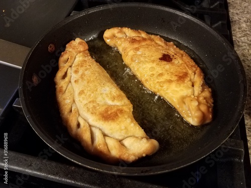 Puerto Rican pastry with cheese filling in oil