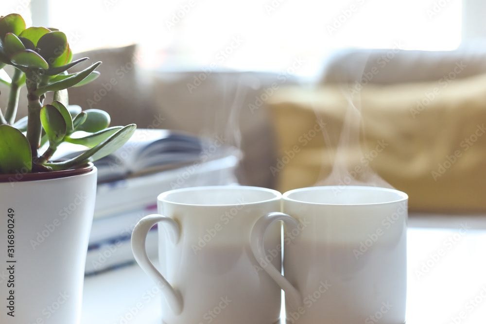 Relaxing sofa area with coffee table and hot drink in modern home interior Relaxing sofa area with coffee table and hot drink in modern home interior