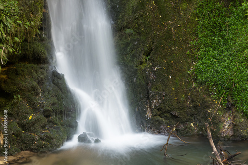 Long exposure photograph of the foot of a ten metres tall waterfall in McLaren Falls Park, Bay of Plenty, New Zealand.