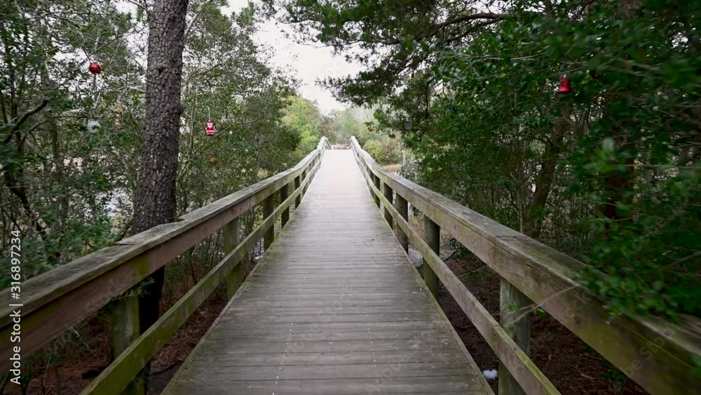 Walking down the boardwalk away from the beach. I calm day leaving Oak Island beach NC. Walking down the boardwalk away from the beach. I calm day leaving Oak Island beach NC.