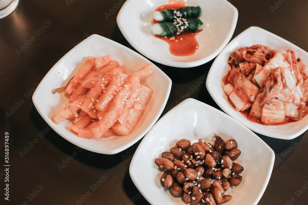 hand holding chopsticks for eating Kimchi salad in restaurant. Korean food traditional Kimchi.Korean food traditional cuisine. Fermented food. Vegetarian food good for health, Vegan for weight control