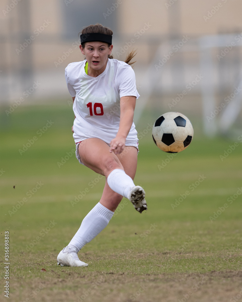 Young athletic girl playing in a soccer match