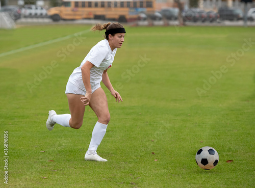 Young athletic girl playing in a soccer match © Joe