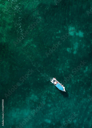 Aerial photography of a boat in the caribbean sea