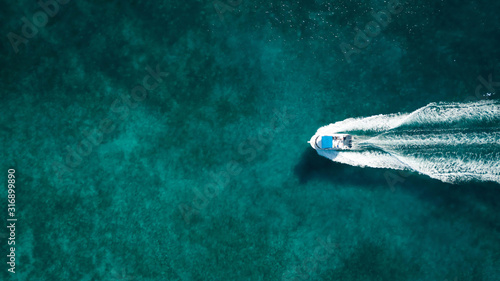 Aerial photography of a boat in the caribbean sea photo