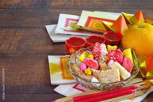 Canvas Print Set of colorful snack, Mandarin orange, Tea, candle, incense stick and joss money paper for worship to Taoism Gods / Goddess and ancestors in Chinese cultures in all Chinese Festival