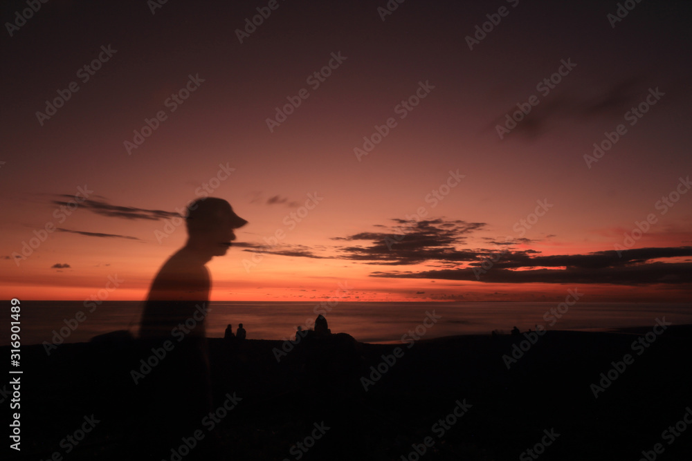 silhouette of man at sunset with blank space for text