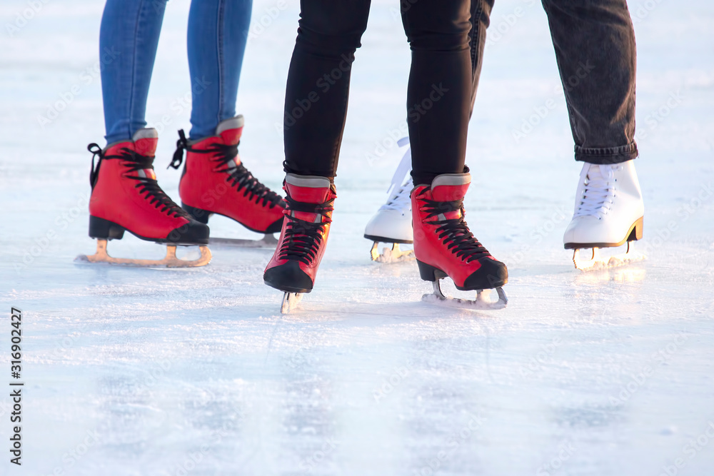 people ice skating on an ice rink. hobbies and leisure. winter sports people ice skating on an ice rink. hobbies and leisure. winter sports