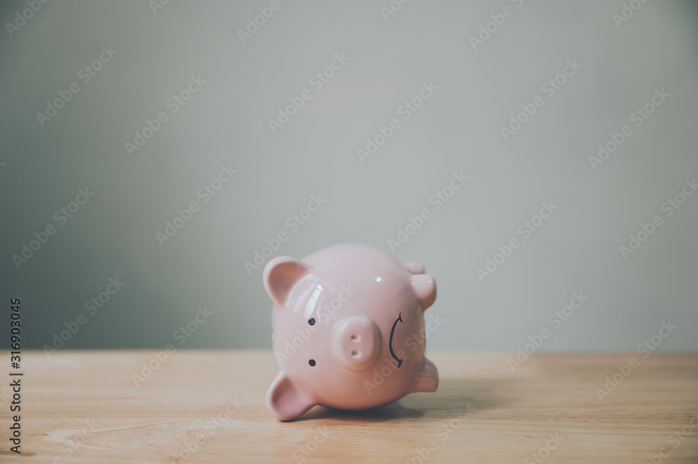 Piggy bank on wood table. Financial investment and save money concept - obrazy, fototapety, plakaty 